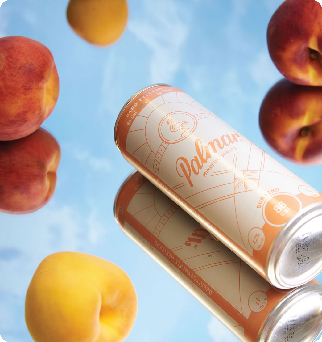 Two cans of refreshing beverage with a peach flavor from palmar brand