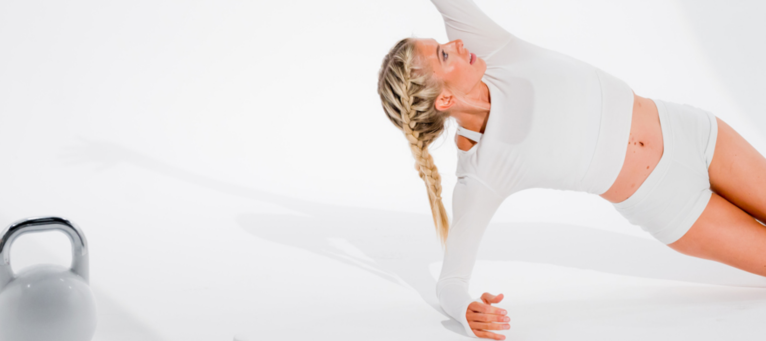 Woman doing yoga pose in white sport clothes